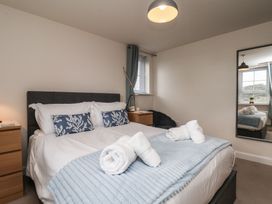 A bedroom with a bed and bedside table at Larpool Retreat in Whitby
