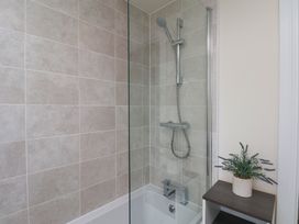 A bathroom with a shower and bathtub at Larpool Retreat in Whitby