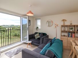 A living room with a sofa and bookshelf at Larpool Retreat in Whitby