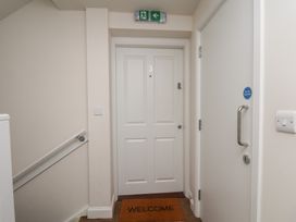 A hallway with a door and welcome mat at Larpool Retreat in Whitby