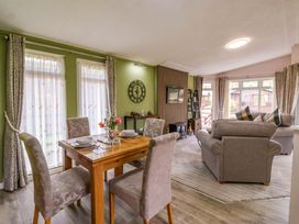 A living room with a dining area and a sofa at Badgers Retreat - Two Dales Richmond