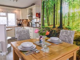 A dining area with a wood table and chairs at Badgers Retreat - Two Dales, Richmond