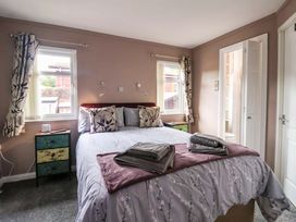 A bedroom with a bed and bedside table at Badgers Retreat - Two Dales in Richmond