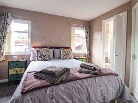 A bedroom with a bed and a nightstand at Badgers Retreat - Two Dales, Richmond
