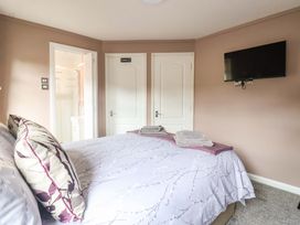 A bedroom with a bed and television at Badgers Retreat - Two Dales, Richmond