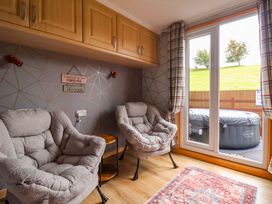 A snug with two armchairs and a window at Badgers Retreat - Two Dales Richmond