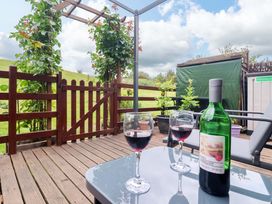A garden area with wine glasses on a table at Badgers Retreat - Two Dales, Richmond