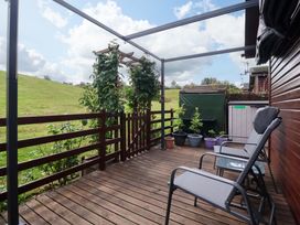 An outdoor terrace with chairs and plants at Badgers Retreat - Two Dales in Richmond