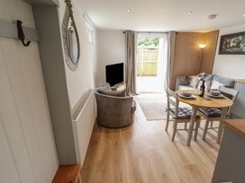A living room with a table and chairs at Pear Tree Lodge in Alford