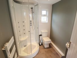 A bathroom with a shower and toilet at Pear Tree Lodge in Alford