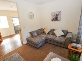 A living room with a sofa and wall art at Vern Dale in Builth Wells