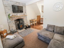 A living room with a stove and television at Vern Dale in Builth Wells