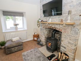 A living room with a fireplace and television at Vern Dale in Builth Wells