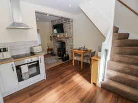 A kitchen with dining table and fireplace at Vern Dale in Builth Wells