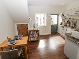 A kitchen with a table and chairs at Vern Dale in Builth Wells