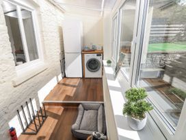A utility room with a washing machine and refrigerator at Vern Dale in Builth Wells
