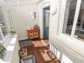 A conservatory with a console table and windows at Vern Dale in Builth Wells