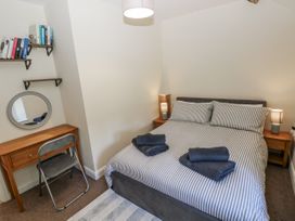 A bedroom with a bed, desk and bookshelf at Vern Dale in Builth Wells