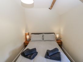 A bedroom with a bed and towels on the bedding at Vern Dale in Builth Wells