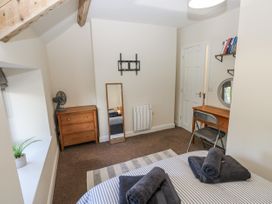 A bedroom with a bed and dresser at Vern Dale Builth Wells
