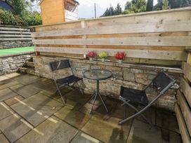 An outdoor sitting area with two chairs and a table at Vern Dale in Builth Wells