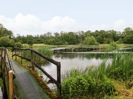 A bridge over water in a natural setting at Oak Lodge in Mynydd Cerrig near Porthyrhyd