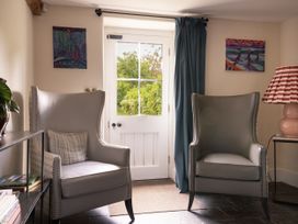 A living room with two armchairs and a door at West Cottage Llandovery