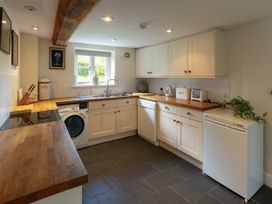 A kitchen with cabinets and appliances at West Cottage Llandovery