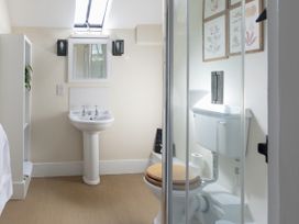 A bathroom with a sink, toilet, and shower at West Cottage in Llandovery