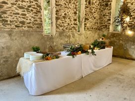 A dining room with a table set for food at West Cottage in Myddfai near Llandovery