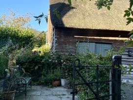 A garden with a wooden building and bench at West Cottage in Myddfai near Llandovery