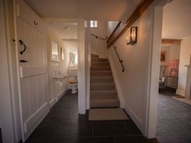 A hallway with a staircase and a toilet at West Cottage Myddfai near Llandovery