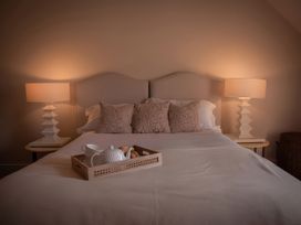 A bedroom with a bed and bedside tables at West Cottage near Llandovery