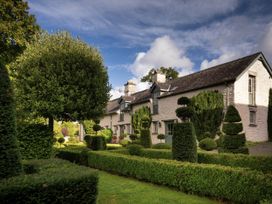 A house with a garden and trimmed hedges at West Cottage in Myddfai near Llandovery