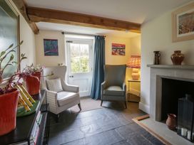 A living room with chairs and a fireplace at West Cottage in Myddfai near Llandovery
