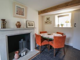 A dining room with a round table and chairs at West Cottage Myddfai near Llandovery
