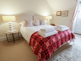 A bedroom with a bed and pillows at West Cottage in Myddfai near Llandovery