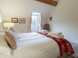 A bedroom with double bed and side table at West Cottage in Myddfai near Llandovery