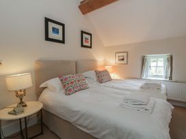 A bedroom with twin beds and bedside table at West Cottage Myddfai near Llandovery