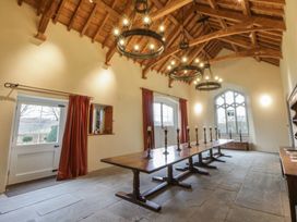 A dining room with a long table and candles at West Cottage in Myddfai near Llandovery