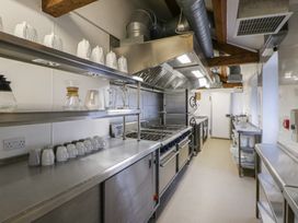 A kitchen with stainless steel counters and cooking equipment at West Cottage in Myddfai near Llandovery