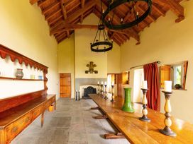 A dining room with a long table and candles at Gatekeepers Cottage in Llandovery
