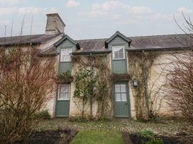 An outdoor view of a cottage with green doors at Gatekeepers Cottage Myddfai near Llandovery