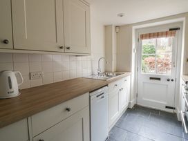 A kitchen with cabinets and a sink at Gatekeepers Cottage Myddfai near Llandovery