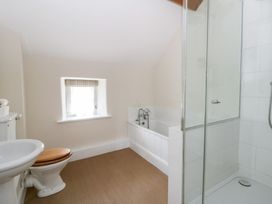A bathroom with a bathtub and shower at Gatekeepers Cottage Myddfai near Llandovery