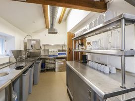 A kitchen with stainless steel appliances and shelving at Gatekeepers Cottage Myddfai near Llandovery