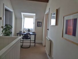 A hallway with a desk and chair at Gatekeepers Cottage Myddfai near Llandovery