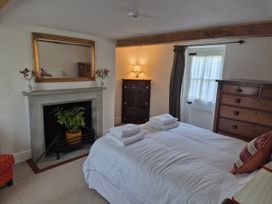 A bedroom with a bed and a fireplace at Gatekeepers Cottage Myddfai near Llandovery