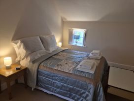 A bedroom with a bed and bedside table at Gatekeepers Cottage in Myddfai near Llandovery
