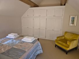 A bedroom with a bed and wardrobe at Gatekeepers Cottage near Llandovery